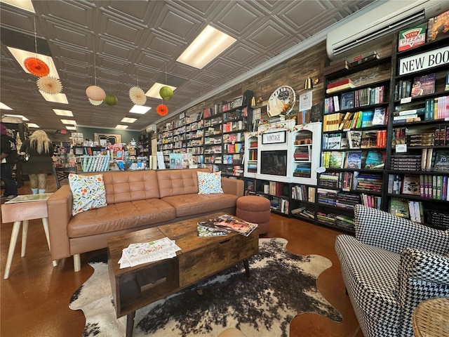 sitting room featuring a wall unit AC and an ornate ceiling