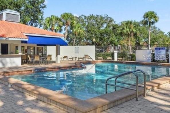 4706 Sutton Ter Unit 111A2, Orlando, FL 32811 - community pool featuring a patio area