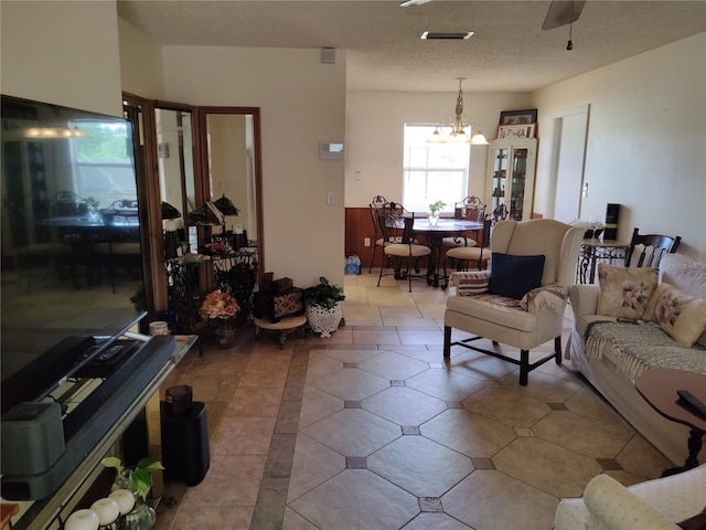 living room with visible vents and a notable chandelier