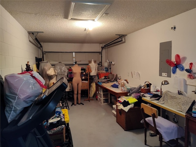 garage with electric panel and concrete block wall
