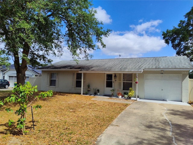 single story home with a garage, stucco siding, a porch, a front yard, and driveway