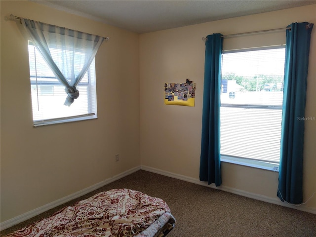 bedroom featuring carpet floors and baseboards