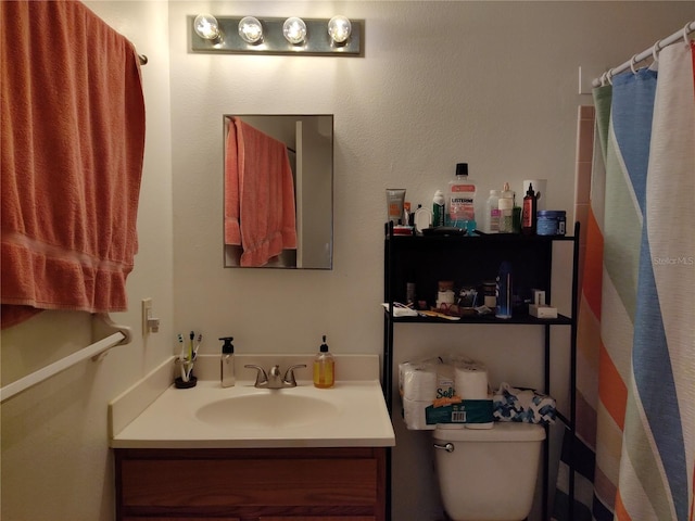 full bath featuring vanity and toilet