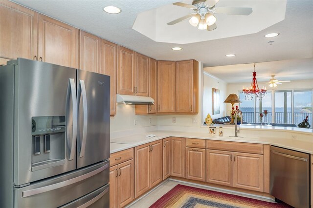 490 Sail Ln Unit 702, Merritt Island, FL 32953 - kitchen with light countertops, stainless steel appliances, under cabinet range hood, a sink, and ceiling fan with notable chandelier