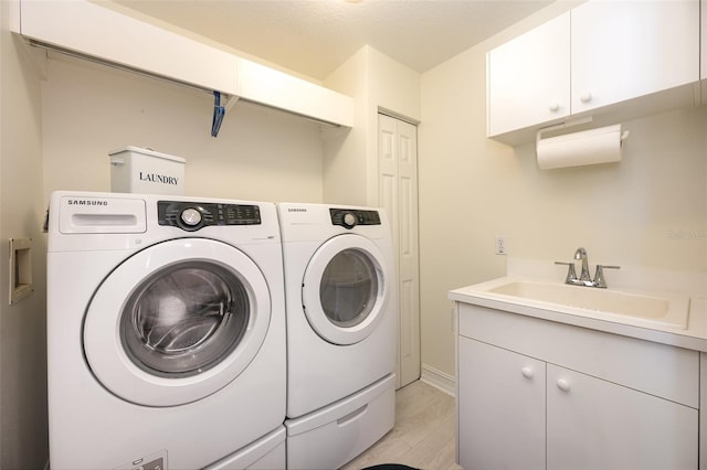 490 Sail Ln Unit 702, Merritt Island, FL 32953 - clothes washing area with a sink, cabinet space, and separate washer and dryer