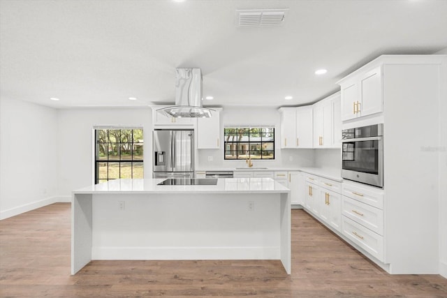 345 W Hornbeam Dr, Longwood, FL 32779 - kitchen featuring visible vents, a center island, a sink, light countertops, and stainless steel appliances