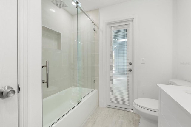 345 W Hornbeam Dr, Longwood, FL 32779 - full bathroom with vanity, bath / shower combo with glass door, wood finished floors, and toilet
