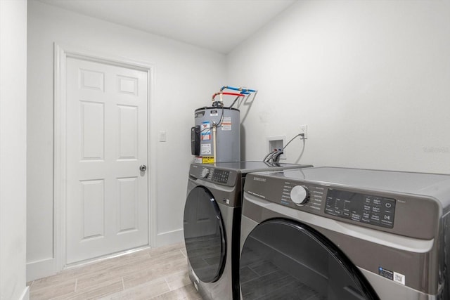 345 W Hornbeam Dr, Longwood, FL 32779 - laundry area featuring laundry area, baseboards, wood finish floors, gas water heater, and separate washer and dryer