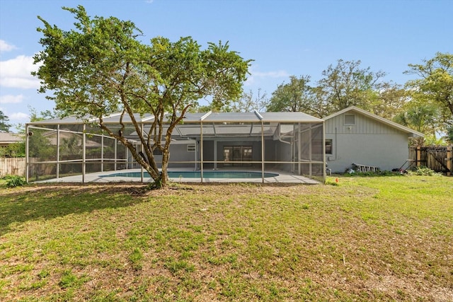 345 W Hornbeam Dr, Longwood, FL 32779 - back of house featuring a fenced in pool, glass enclosure, fence, and a yard