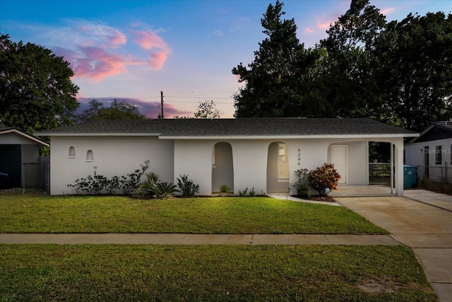 4246 Clarinda St, Orlando, FL 32811 - ranch-style home with stucco siding, a shingled roof, and a front yard