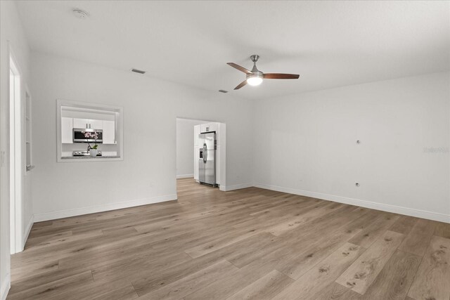 4246 Clarinda St, Orlando, FL 32811 - empty room with light wood finished floors, baseboards, visible vents, and a ceiling fan
