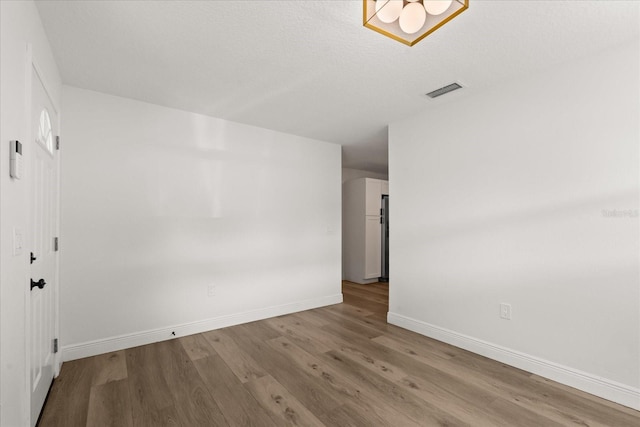 4246 Clarinda St, Orlando, FL 32811 - spare room with visible vents, baseboards, and wood finished floors