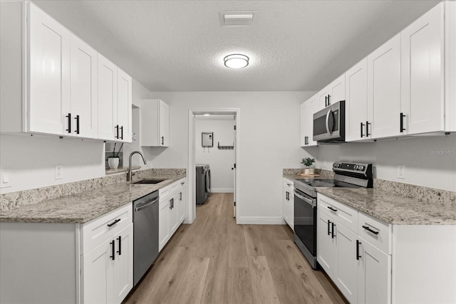 4246 Clarinda St, Orlando, FL 32811 - kitchen featuring a sink, visible vents, white cabinets, and appliances with stainless steel finishes
