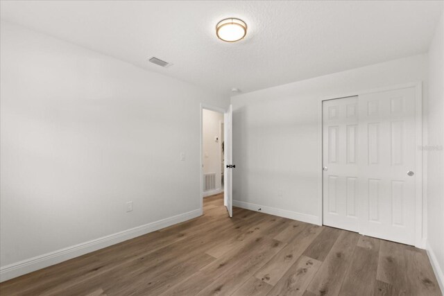 4246 Clarinda St, Orlando, FL 32811 - unfurnished bedroom with visible vents, baseboards, a closet, and wood finished floors