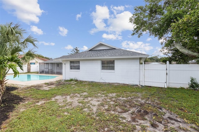 3994 Irma Shores Dr, Orlando, FL 32817 - rear view of house with fence, a fenced in pool, a gate, a shingled roof, and a lawn