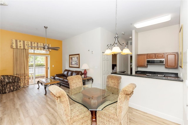 8100 Poinciana Blvd Unit 2109, Orlando, FL 32821 - dining room with baseboards, ceiling fan, and light wood-type flooring