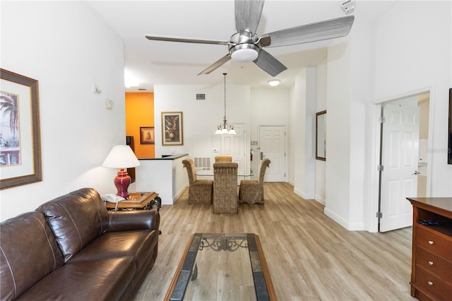 8100 Poinciana Blvd Unit 2109, Orlando, FL 32821 - living area with baseboards, visible vents, light wood-style flooring, and ceiling fan with notable chandelier