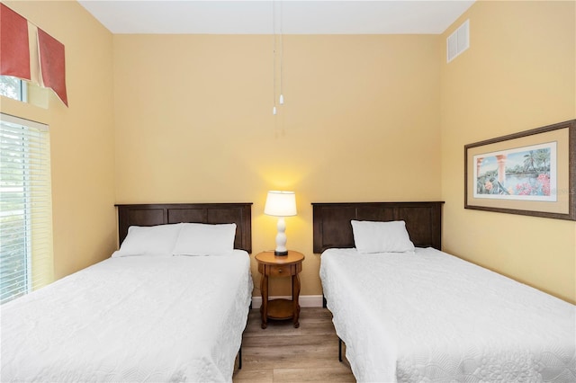 8100 Poinciana Blvd Unit 2109, Orlando, FL 32821 - bedroom with baseboards, visible vents, and wood finished floors