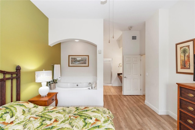 8100 Poinciana Blvd Unit 2109, Orlando, FL 32821 - bedroom with arched walkways, baseboards, light wood-style floors, and visible vents