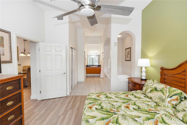 8100 Poinciana Blvd Unit 2109, Orlando, FL 32821 - bedroom with connected bathroom, a ceiling fan, light wood-type flooring, visible vents, and arched walkways
