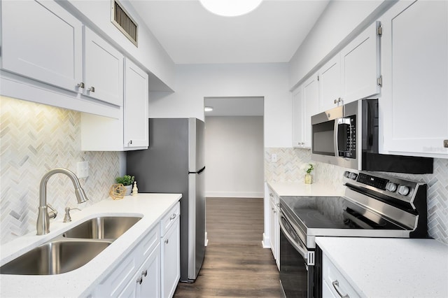 1140 S Orlando Ave Unit E-1, Maitland, FL 32751 - kitchen featuring a sink, visible vents, backsplash, appliances with stainless steel finishes, and dark wood-style floors