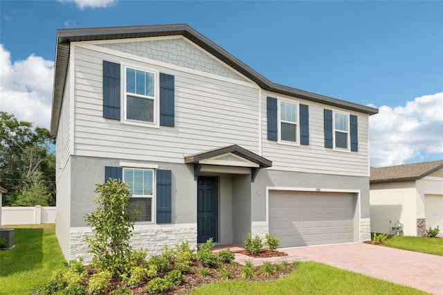 4705 Jasmine Cir, Leesburg, FL 34748 - view of front of property with stone siding, a garage, stucco siding, decorative driveway, and central AC unit