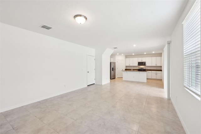 4705 Jasmine Cir, Leesburg, FL 34748 - unfurnished living room with recessed lighting and baseboards