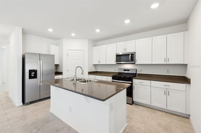 4705 Jasmine Cir, Leesburg, FL 34748 - kitchen with appliances with stainless steel finishes, a sink, dark countertops, white cabinets, and a center island with sink