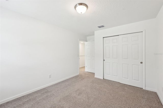 4705 Jasmine Cir, Leesburg, FL 34748 - unfurnished bedroom with carpet flooring, baseboards, a closet, and a textured ceiling