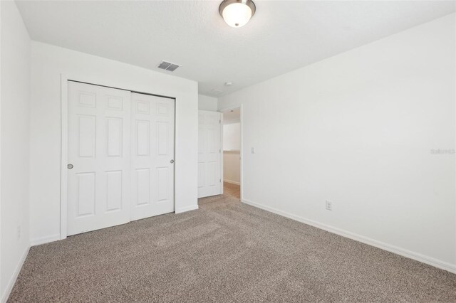 4705 Jasmine Cir, Leesburg, FL 34748 - unfurnished bedroom featuring carpet flooring, baseboards, and a closet