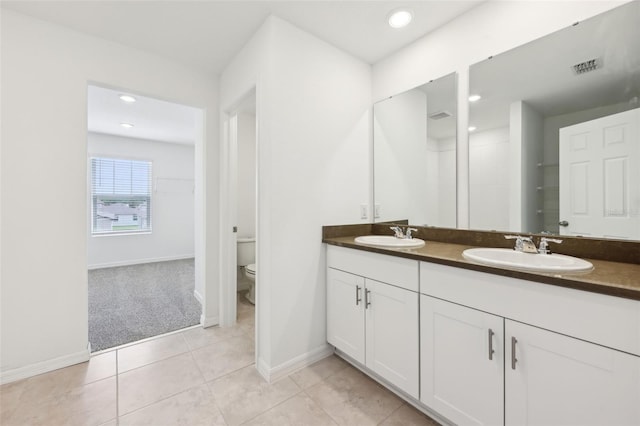 4705 Jasmine Cir, Leesburg, FL 34748 - bathroom featuring toilet, baseboards, double vanity, tile patterned floors, and recessed lighting