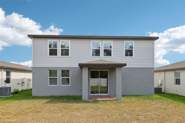 4705 Jasmine Cir, Leesburg, FL 34748 - back of house featuring central AC unit, a yard, and stucco siding