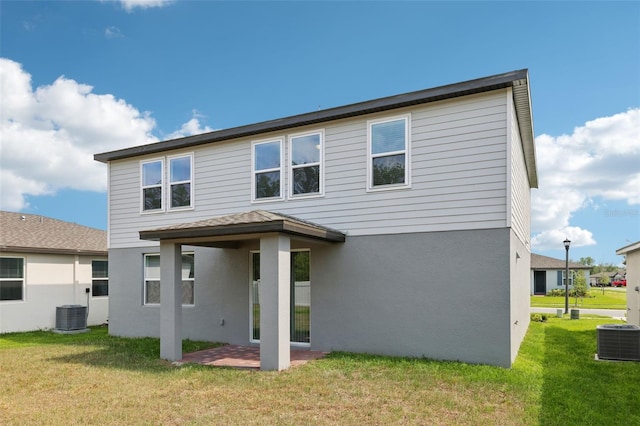 4705 Jasmine Cir, Leesburg, FL 34748 - rear view of property featuring central AC, a patio area, stucco siding, and a yard