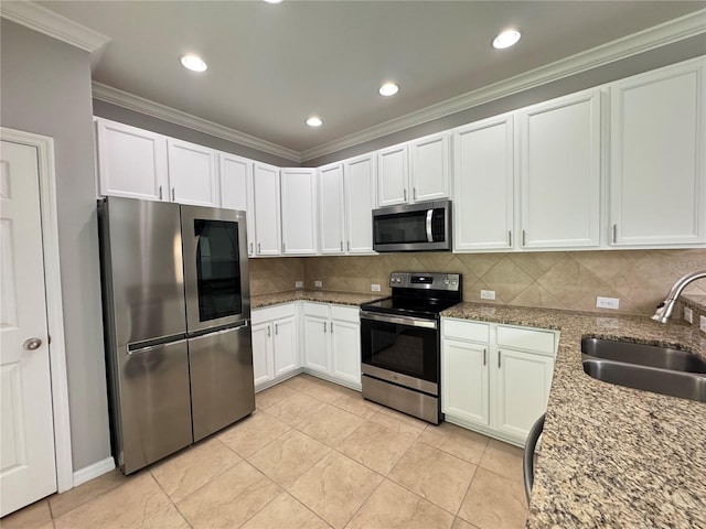 191 Chickasaw Berry Rd, Ocoee, FL 34761 - kitchen featuring appliances with stainless steel finishes, a sink, decorative backsplash, white cabinetry, and crown molding