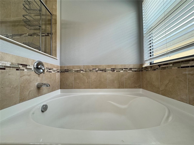 191 Chickasaw Berry Rd, Ocoee, FL 34761 - bathroom featuring a garden tub and a textured wall