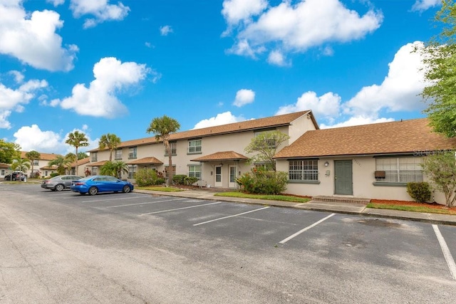 5763 Saint Christopher Dr Unit 55, Orlando, FL 32822 - uncovered parking lot featuring a residential view
