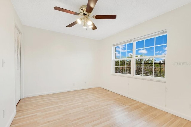 5763 Saint Christopher Dr Unit 55, Orlando, FL 32822 - spare room featuring light wood-style flooring, a textured ceiling, baseboards, and ceiling fan