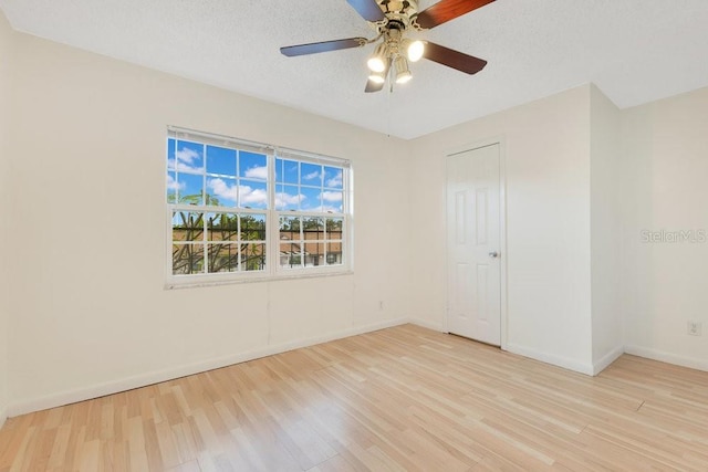 5763 Saint Christopher Dr Unit 55, Orlando, FL 32822 - empty room featuring ceiling fan, baseboards, wood finished floors, and a textured ceiling
