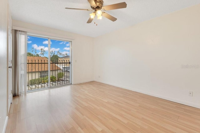 5763 Saint Christopher Dr Unit 55, Orlando, FL 32822 - spare room featuring baseboards, ceiling fan, light wood-style floors, and a textured ceiling