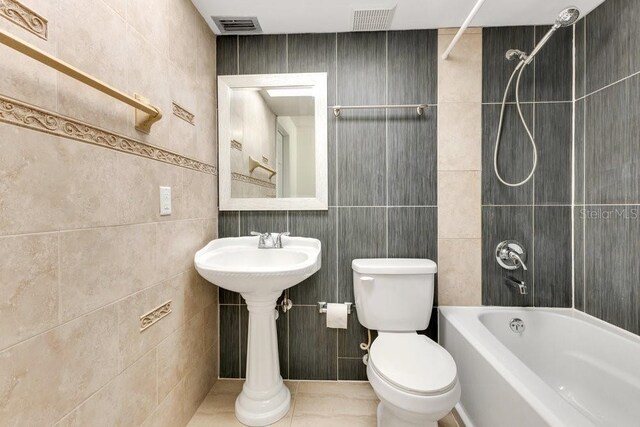 5763 Saint Christopher Dr Unit 55, Orlando, FL 32822 - full bath with toilet, visible vents, shower / bathtub combination, and tile walls