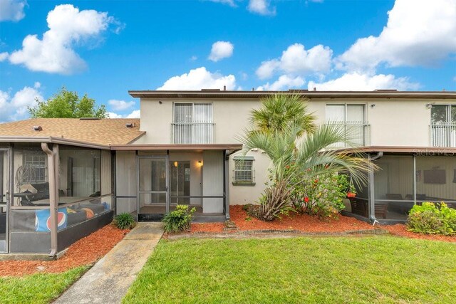 5763 Saint Christopher Dr Unit 55, Orlando, FL 32822 - rear view of house with a yard, stucco siding, and a sunroom