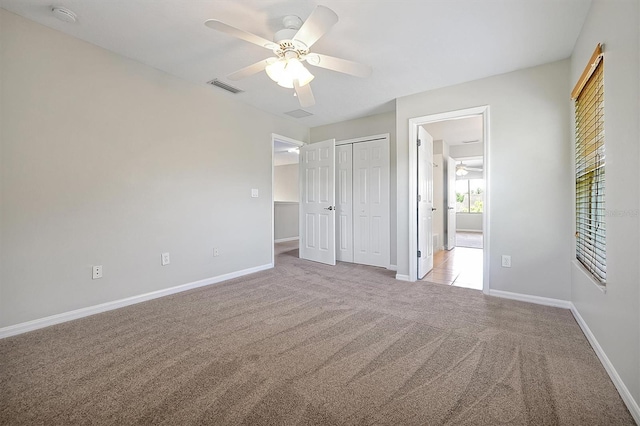 unfurnished bedroom with visible vents, carpet flooring, and baseboards