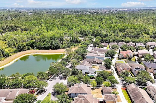birds eye view of property featuring a residential view, a water view, and a forest view
