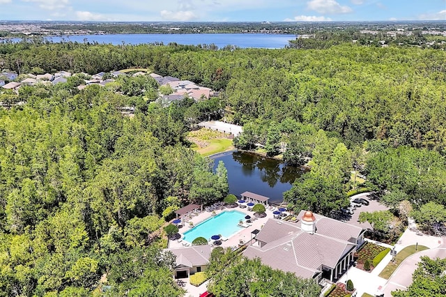 birds eye view of property featuring a water view and a view of trees