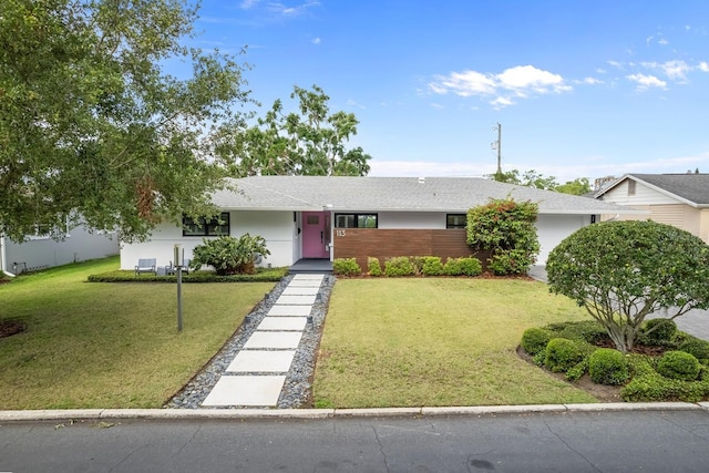 single story home with a front yard and stucco siding