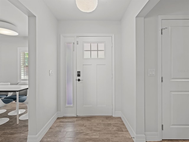 foyer with baseboards and light wood finished floors