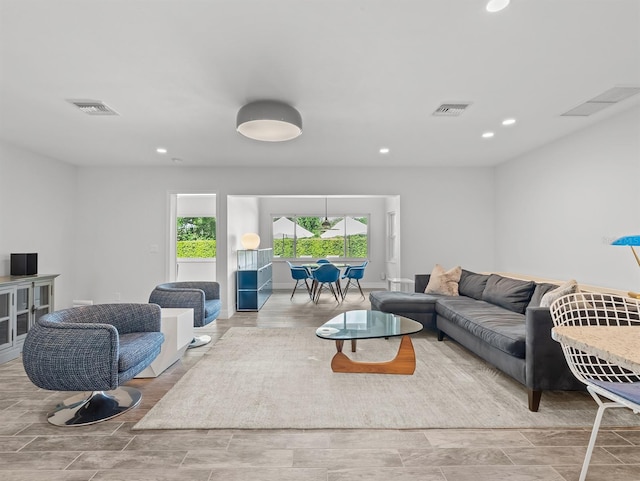 living room featuring wood finish floors, recessed lighting, and visible vents