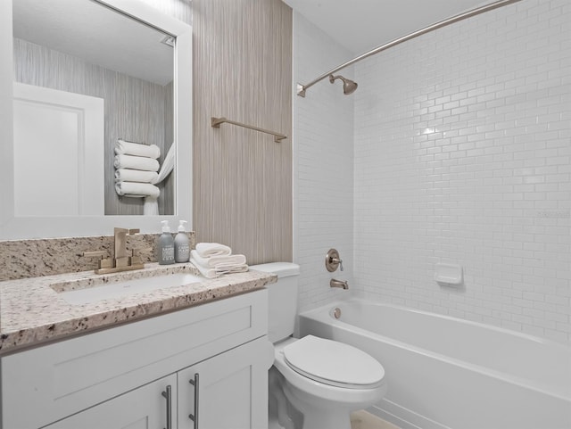 full bathroom with toilet, vanity, and washtub / shower combination