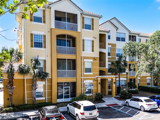 3314 Robert Trent Jones Dr Unit 308, Orlando, FL 32835 - view of building exterior with uncovered parking