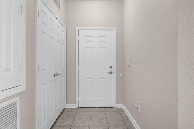 3314 Robert Trent Jones Dr Unit 308, Orlando, FL 32835 - doorway with light tile patterned floors and baseboards